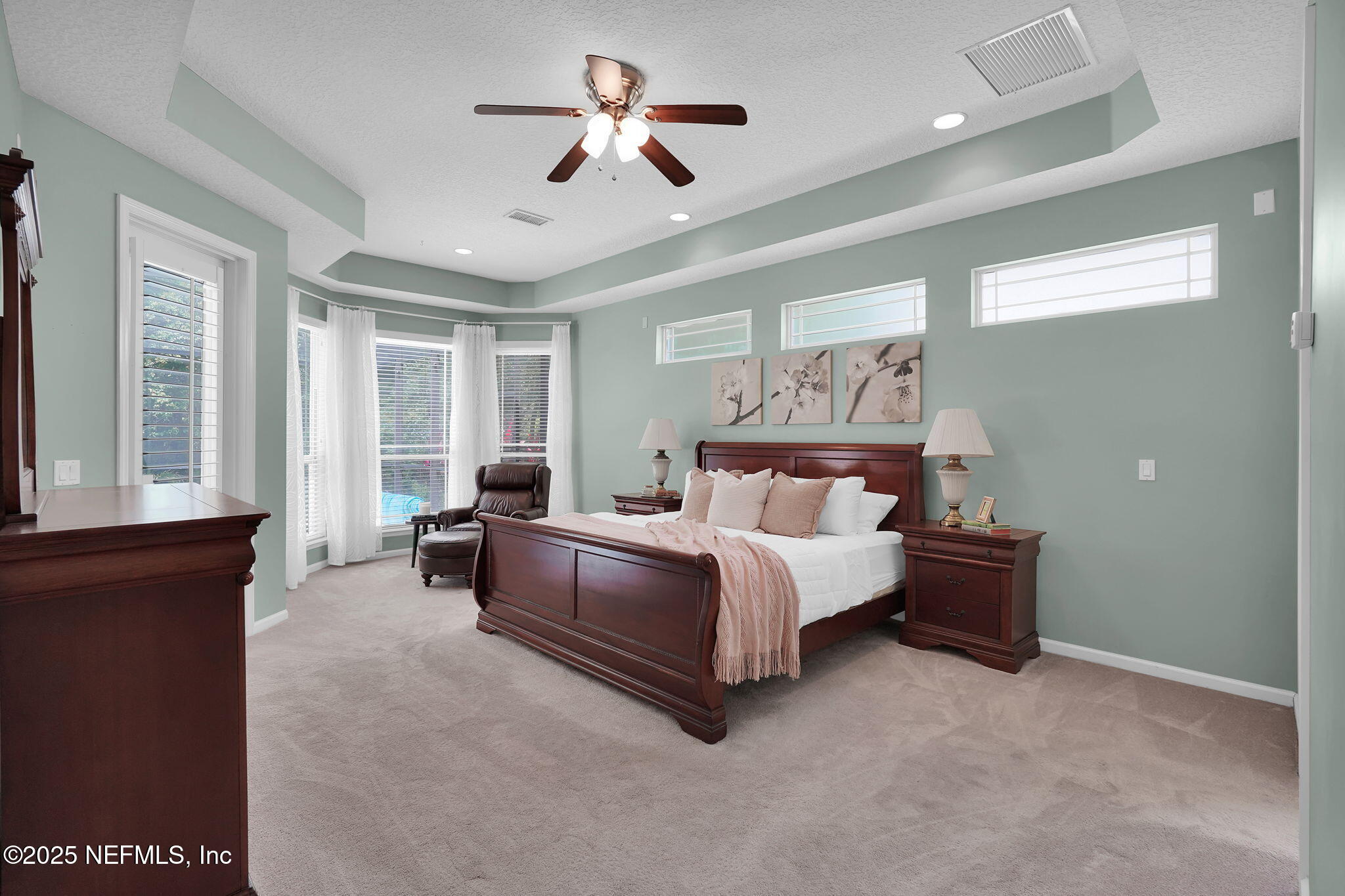 265 Oak Common Avenue St. Augustine, FL 32095 - Photo 34 of 116 a spacious bedroom with a large bed and a chandelier fan