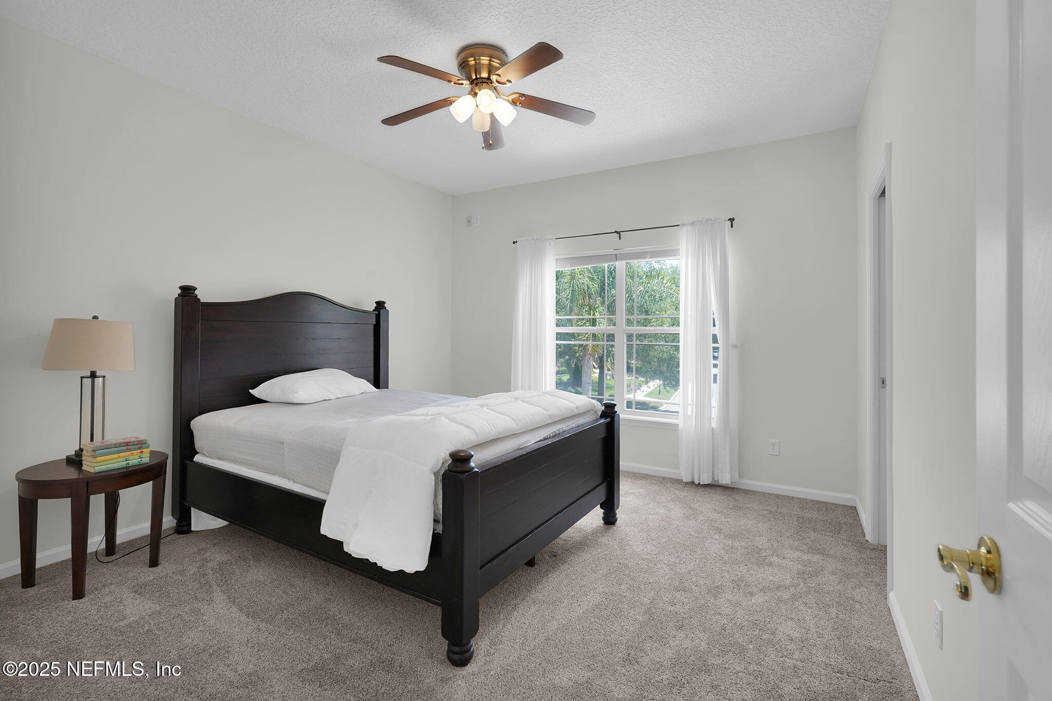 265 Oak Common Avenue St. Augustine, FL 32095 - Photo 52 of 116 a spacious bedroom with a bed and a chandelier