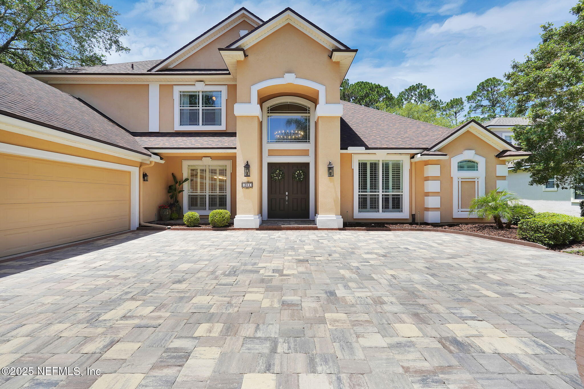265 Oak Common Avenue St. Augustine, FL 32095 - Photo 8 of 116 a front view of a house with a yard and garage