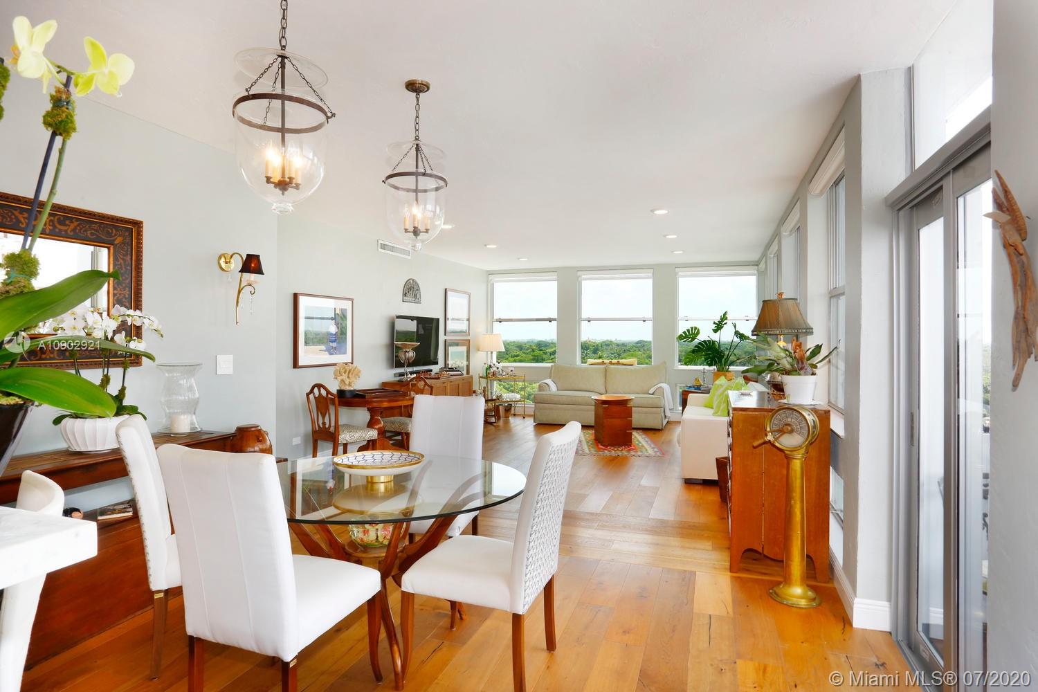 700 Biltmore Way, Unit 910 Coral Gables, FL 33134 - Photo 1 of 26 a dining room with furniture a chandelier and a window