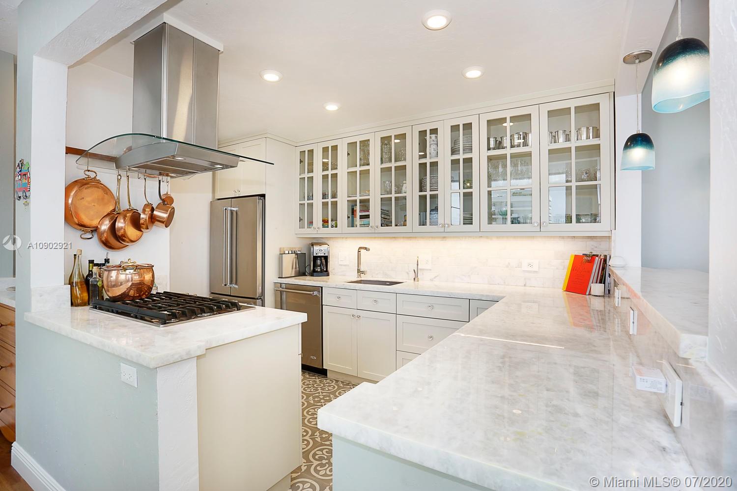 700 Biltmore Way, Unit 910 Coral Gables, FL 33134 - Photo 10 of 26 a kitchen that has a lot of cabinets in it