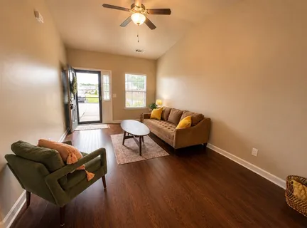 a living room with furniture and a large window