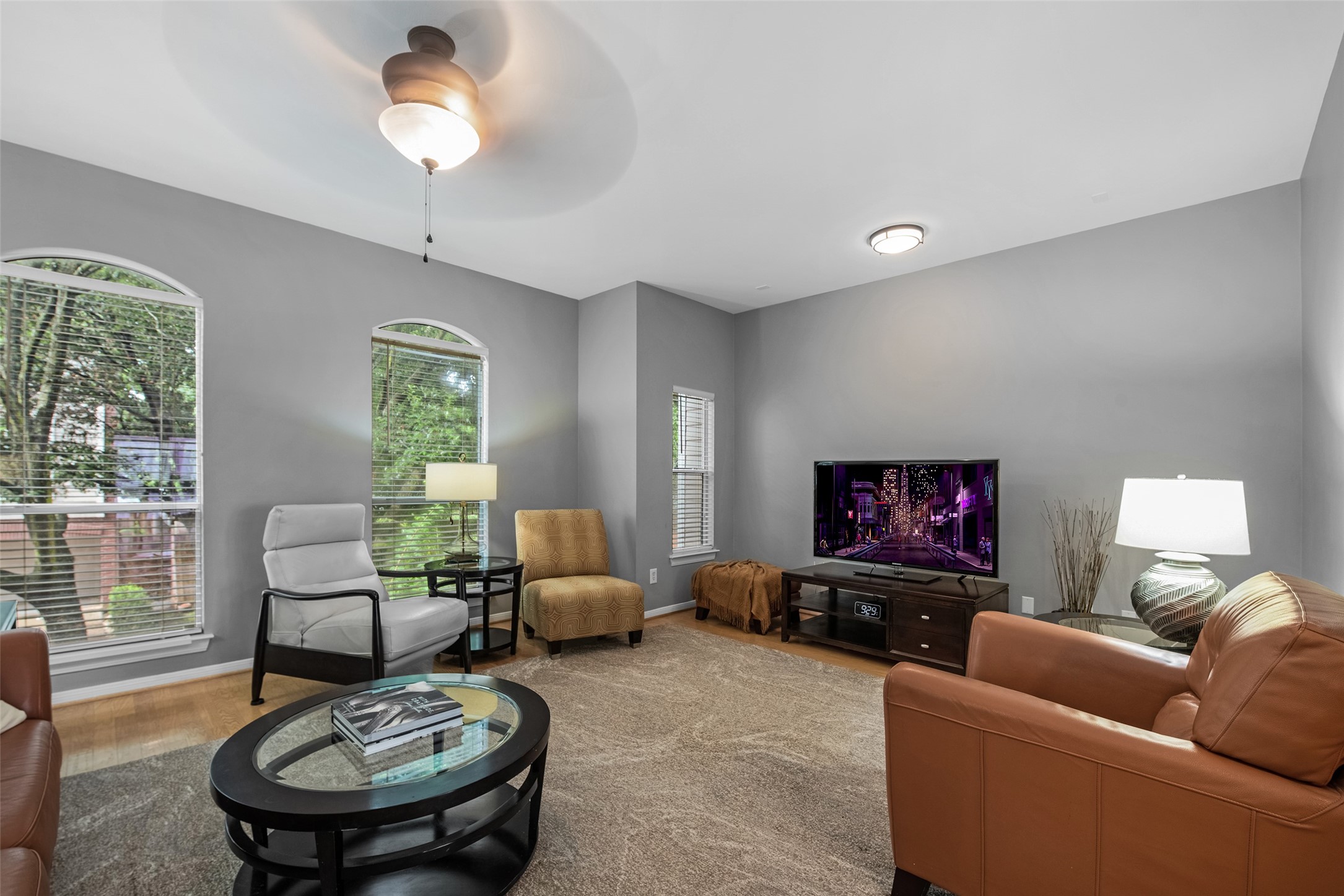 1028 La Rue Street Houston, TX 77019 - Photo 10 of 29 The living room features a peaceful, tree filled view offering privacy while letting in natural light.