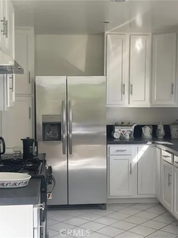 a kitchen with a refrigerator and a sink