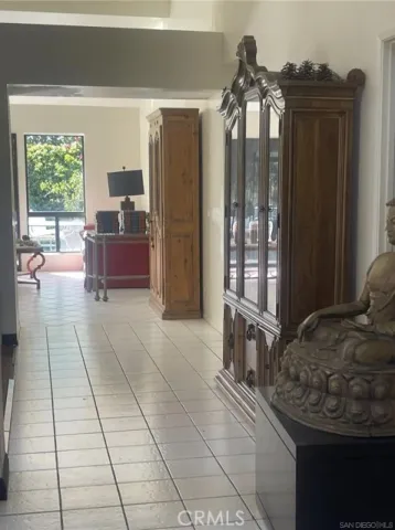 a bedroom with a bed and large windows