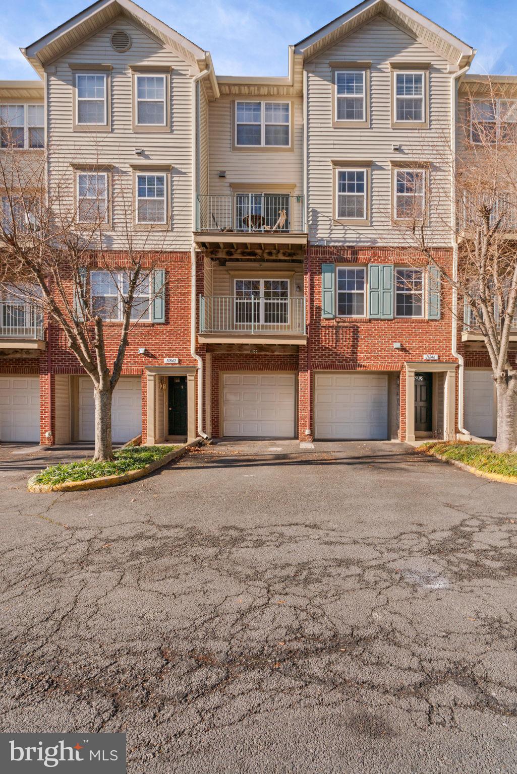 11844 Breton Court, Unit 19A Reston, VA 20191 - Photo 28 of 36 Rear view of the garage entry and driveway