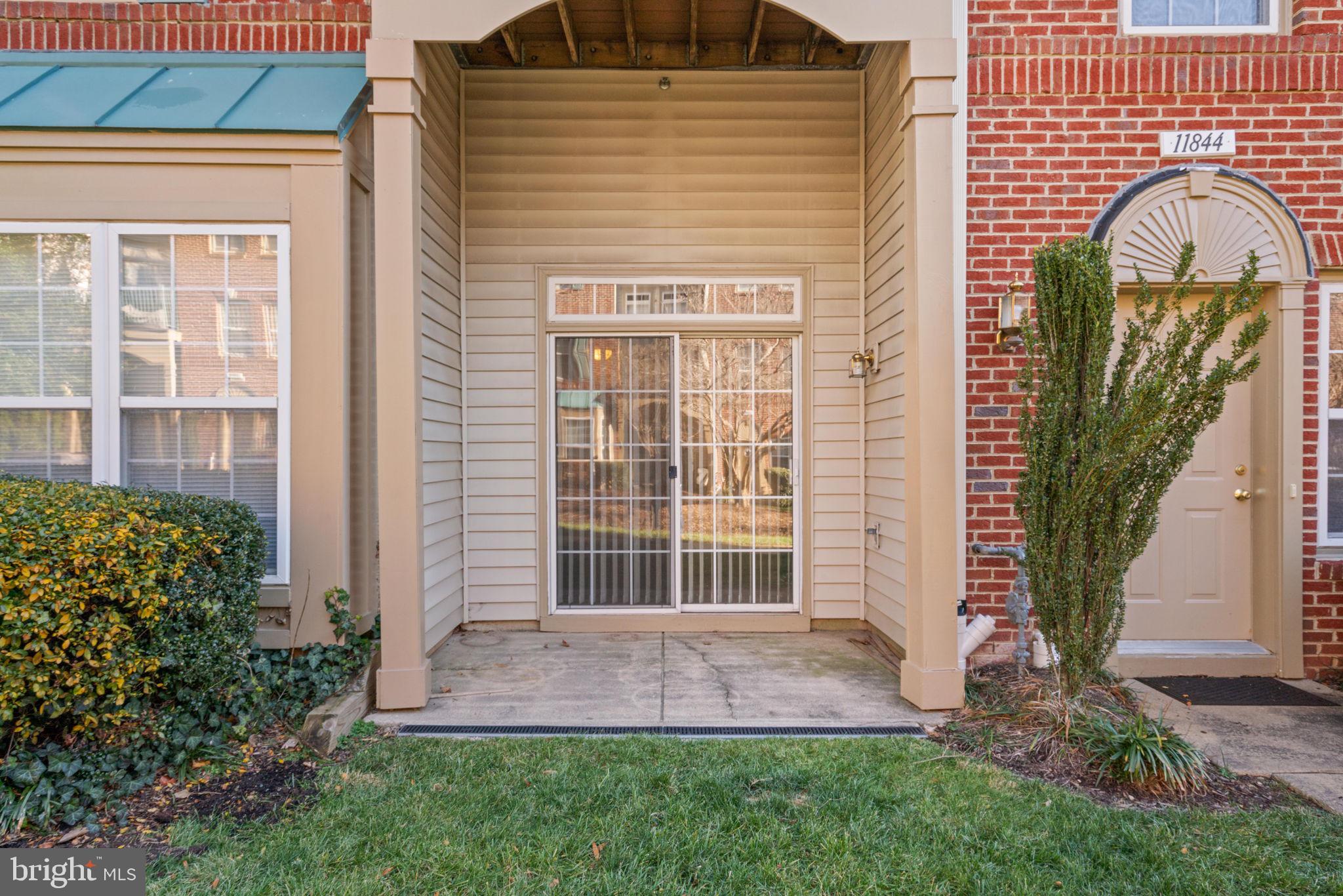 11844 Breton Court, Unit 19A Reston, VA 20191 - Photo 29 of 36 Patio with lawn view and lots of birds to watch