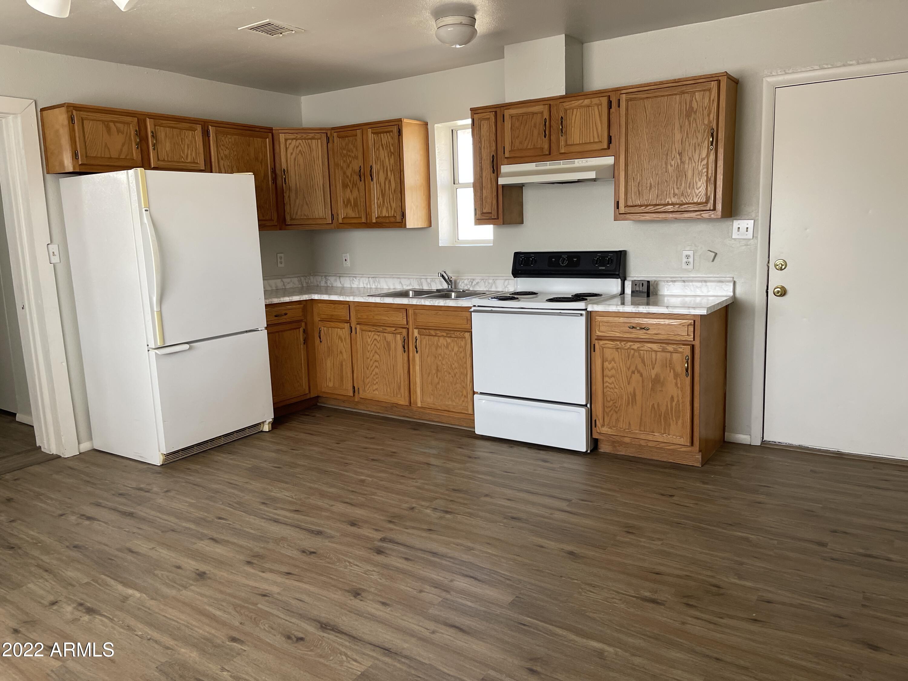 1504 North French Street, Unit B Casa Grande, AZ 85122 - Photo 13 of 23 a kitchen with a refrigerator and a stove top oven