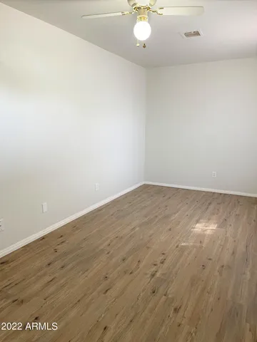an empty room with wooden floor