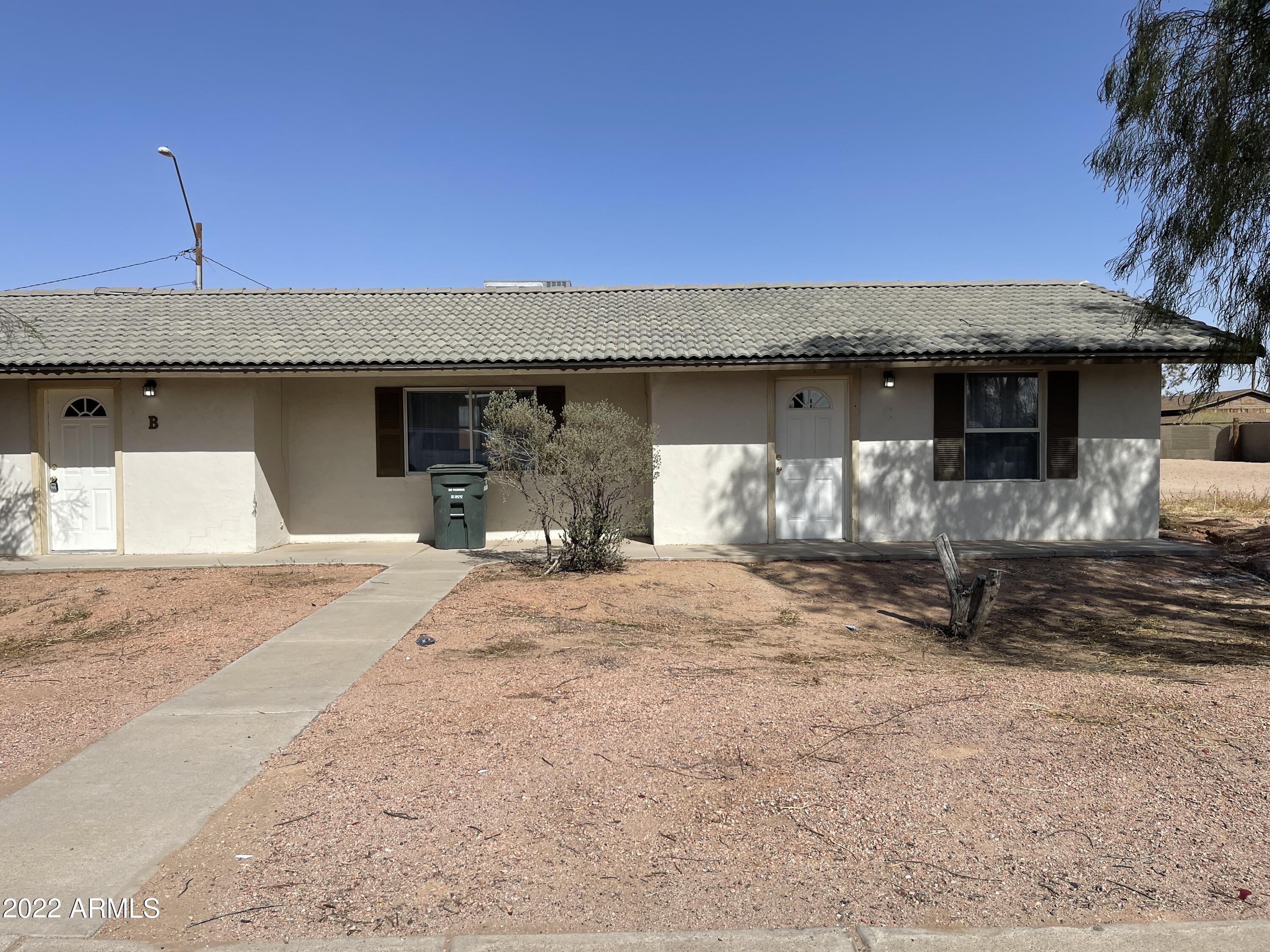 1504 North French Street, Unit B Casa Grande, AZ 85122 - Photo 2 of 23 a backyard of a house with table and chairs