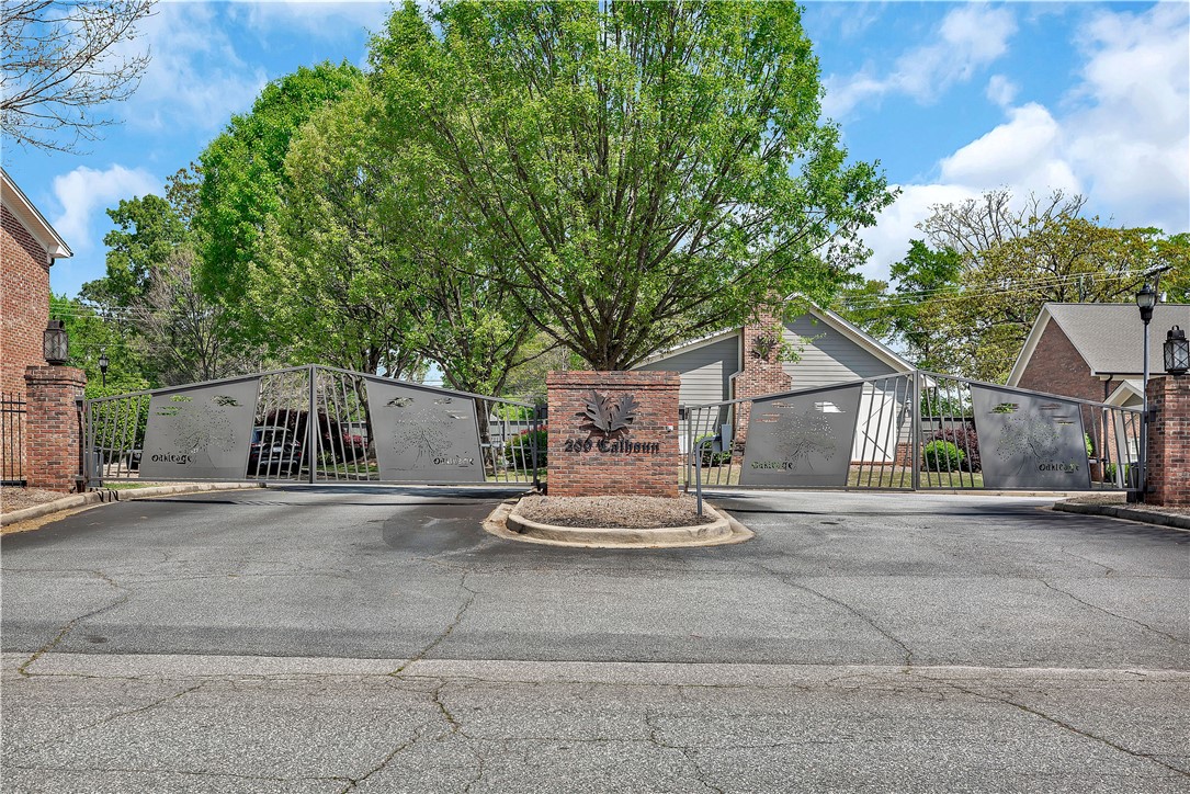 209 Calhoun Street Clemson, SC 29631 - Photo 24 of 25 Secure gated entryway features decorative metal security gates flanked by brick pillars and mature trees.