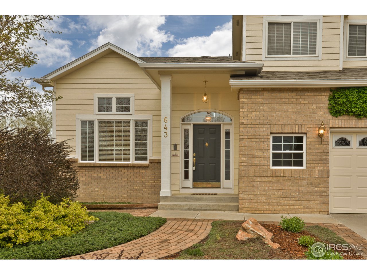 643 Rider Ridge Road Longmont, CO 80504 - Photo 2 of 40 a view of a brick house with a yard