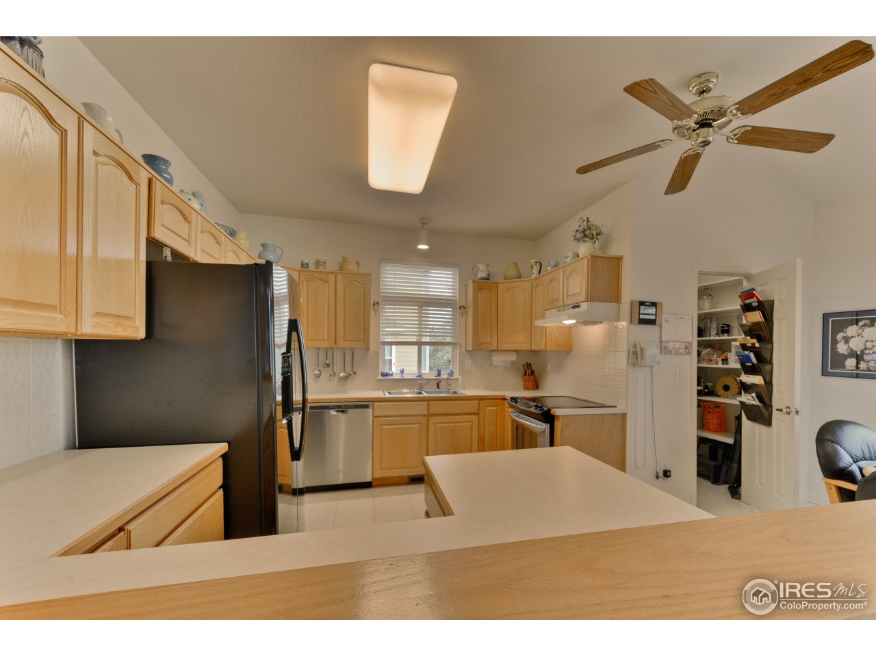 643 Rider Ridge Road Longmont, CO 80504 - Photo 23 of 40 a open kitchen with cabinets and stainless steel appliances