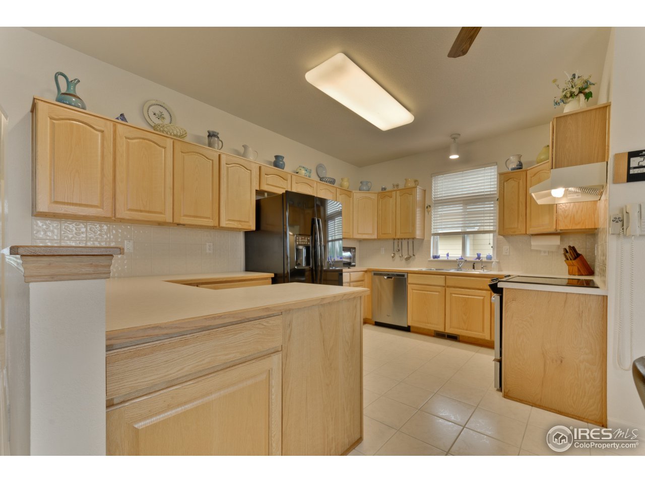 643 Rider Ridge Road Longmont, CO 80504 - Photo 24 of 40 a kitchen with kitchen island a sink stainless steel appliances and cabinets