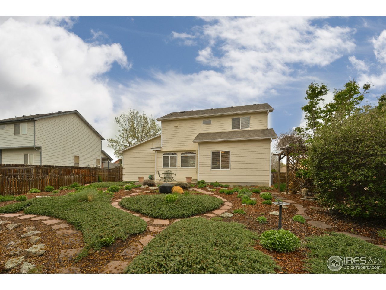 643 Rider Ridge Road Longmont, CO 80504 - Photo 4 of 40 a view of a yard in front of a house with a large tree