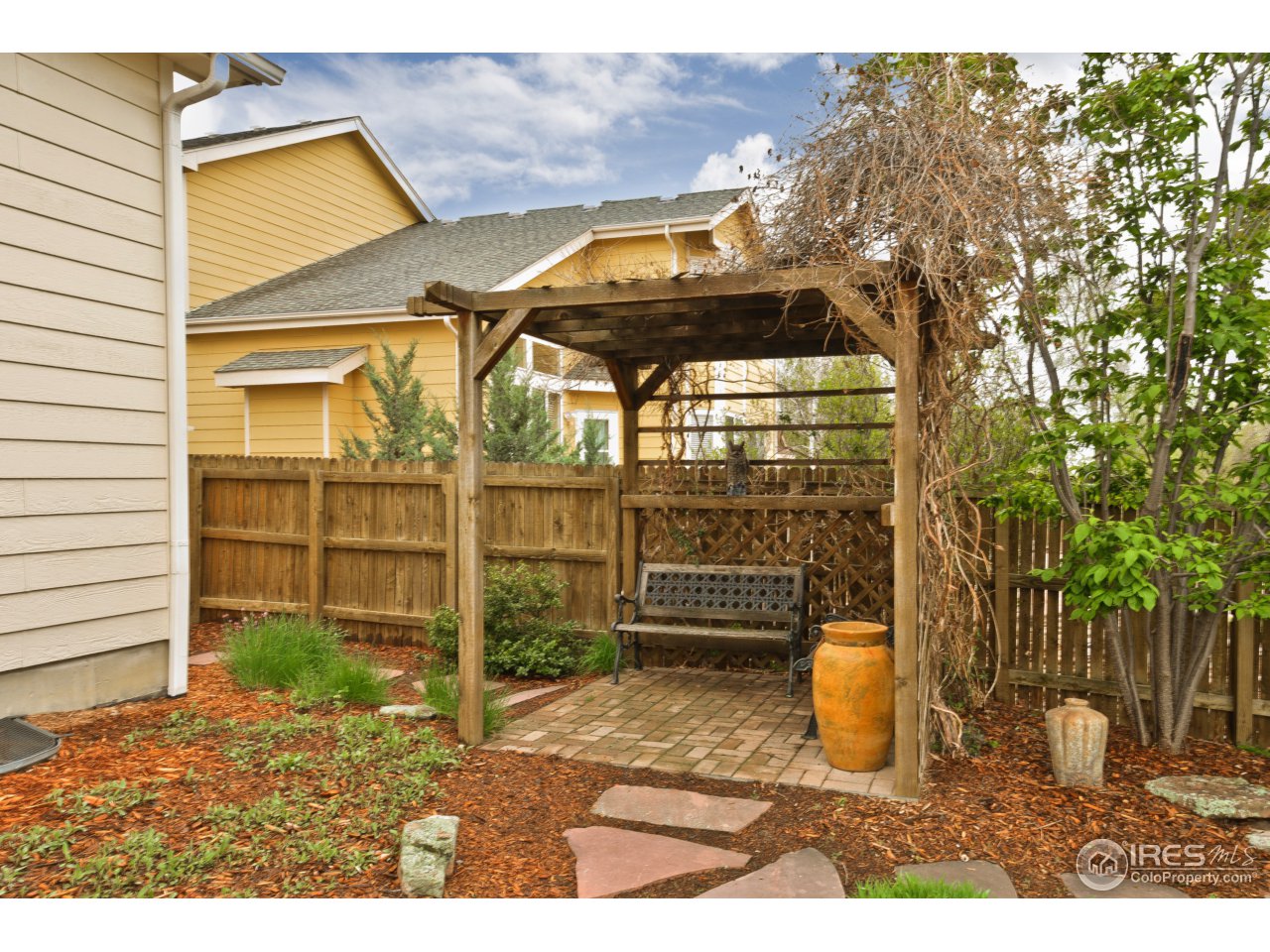 643 Rider Ridge Road Longmont, CO 80504 - Photo 6 of 40 a view of a porch with a door and wooden fence