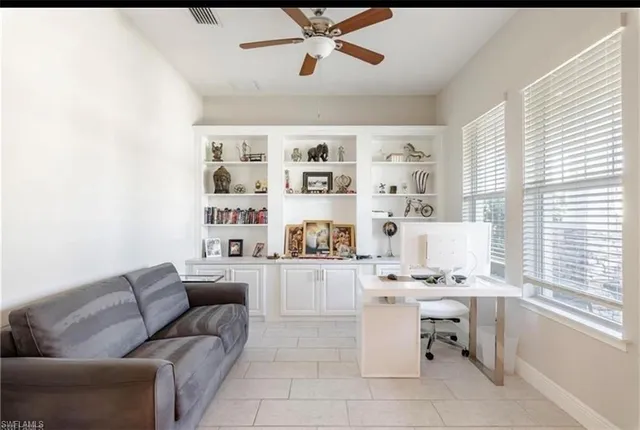a living room with furniture cabinets and window