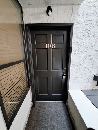 a view of a wooden door of the house