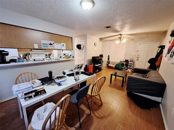 a living room with furniture a rug and a flat screen tv