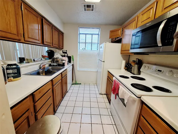 a kitchen with a stove a sink and a refrigerator