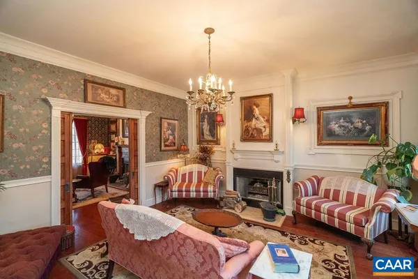 a living room with furniture a rug and a chandelier