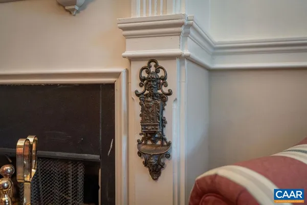 a living room with furniture a fireplace and a chandelier