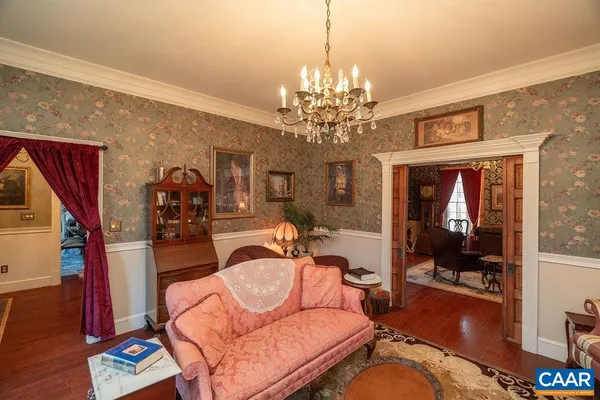a living room with furniture a bookshelf and a fireplace