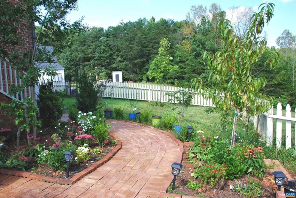a view of a garden with flowers and trees
