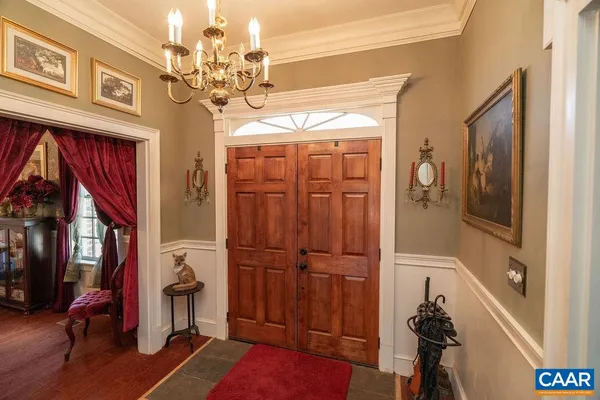 a view of living room with furniture and a chandelier