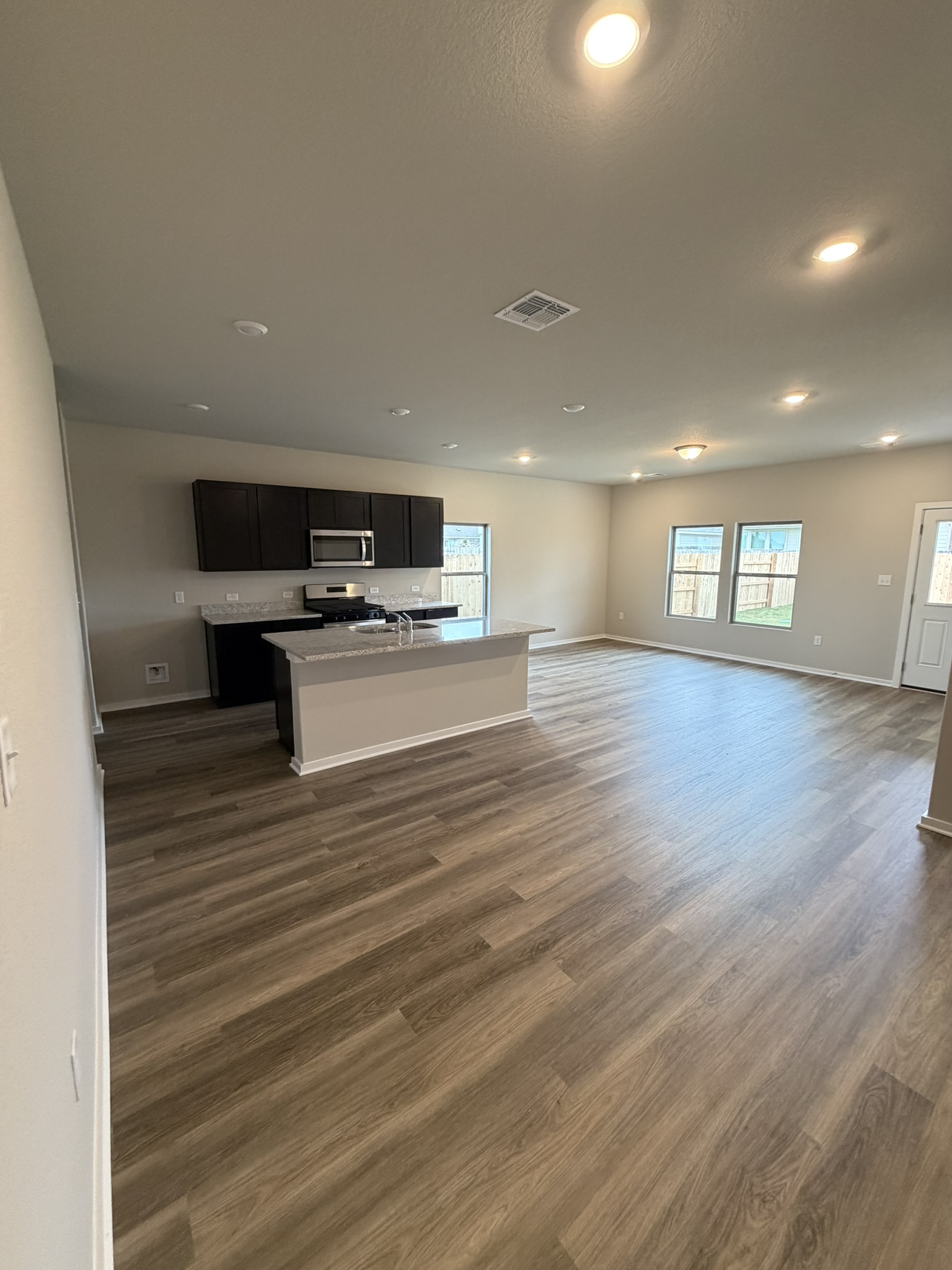 13717 Ryan Range Lane Elgin, TX 78621 - Photo 3 of 20 From Family Room to Open Concept Kitchen