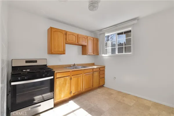 a kitchen with stainless steel appliances granite countertop a stove and a refrigerator