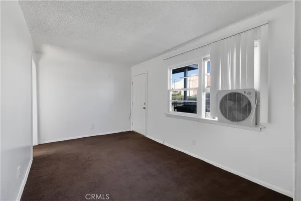 an empty room with fireplace and windows