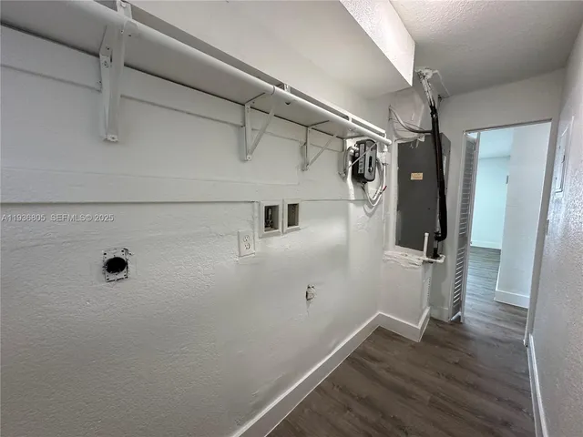 a view of a hallway with wooden floor and cabinet