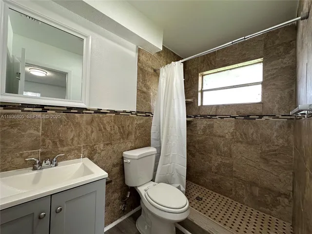 a bathroom with a toilet sink and shower