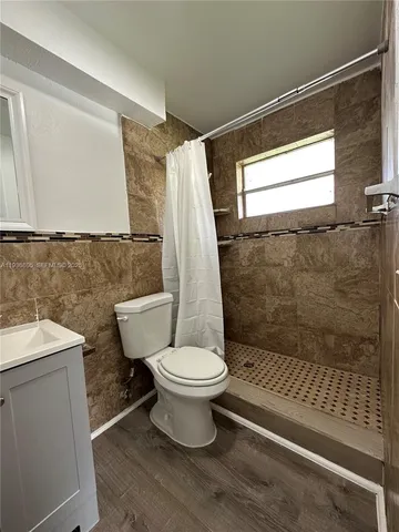 a large kitchen with stainless steel appliances granite countertop a stove a sink and a refrigerator