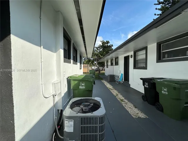 a front view of a house with outdoor seating and plants