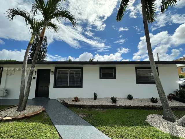 a view of a park with large trees