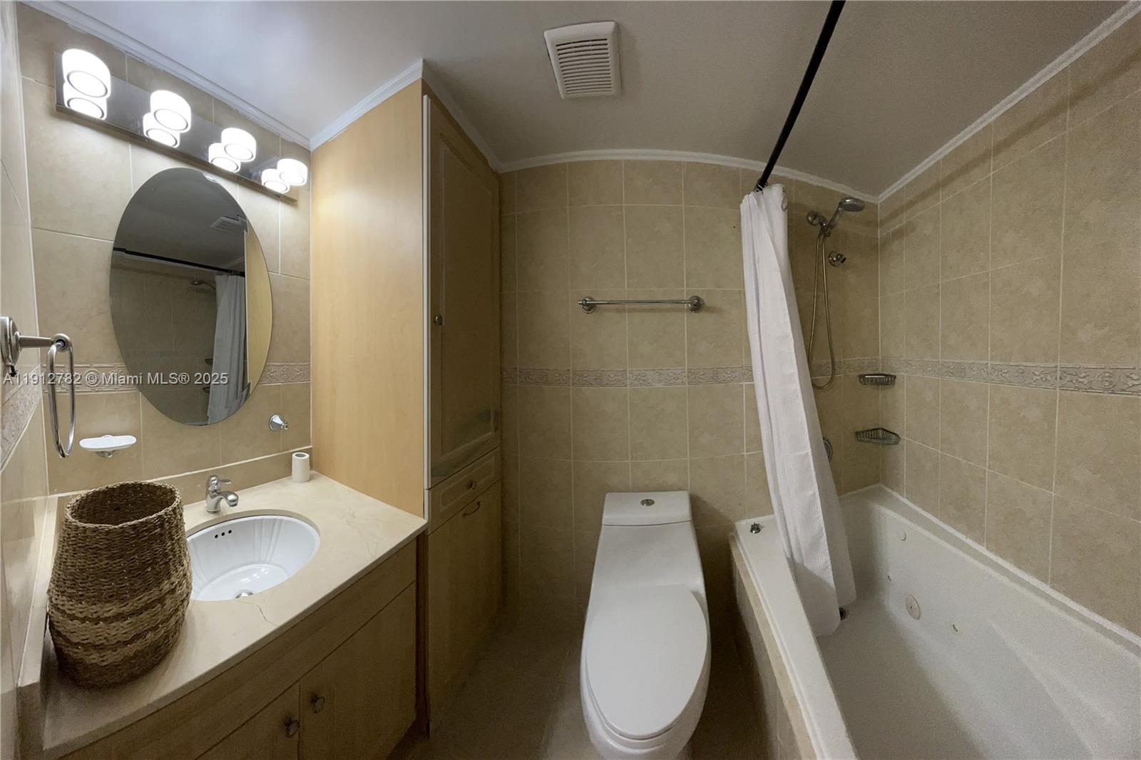 9401 Southwest 4th Street, Unit 111 Miami, FL 33174 - Photo 5 of 12 a bathroom with a granite countertop sink toilet a mirror and shower