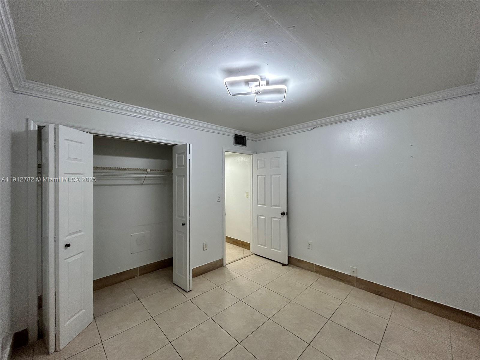 9401 Southwest 4th Street, Unit 111 Miami, FL 33174 - Photo 6 of 12 an empty room with closet area