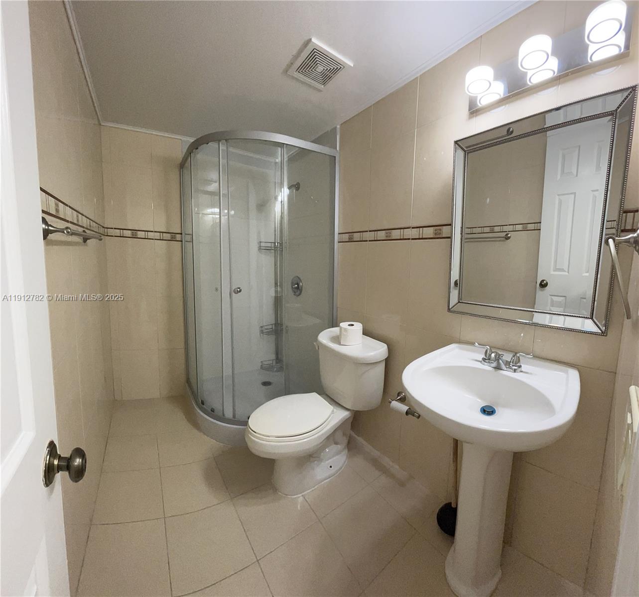 9401 Southwest 4th Street, Unit 111 Miami, FL 33174 - Photo 8 of 12 a bathroom with a sink toilet a mirror and shower