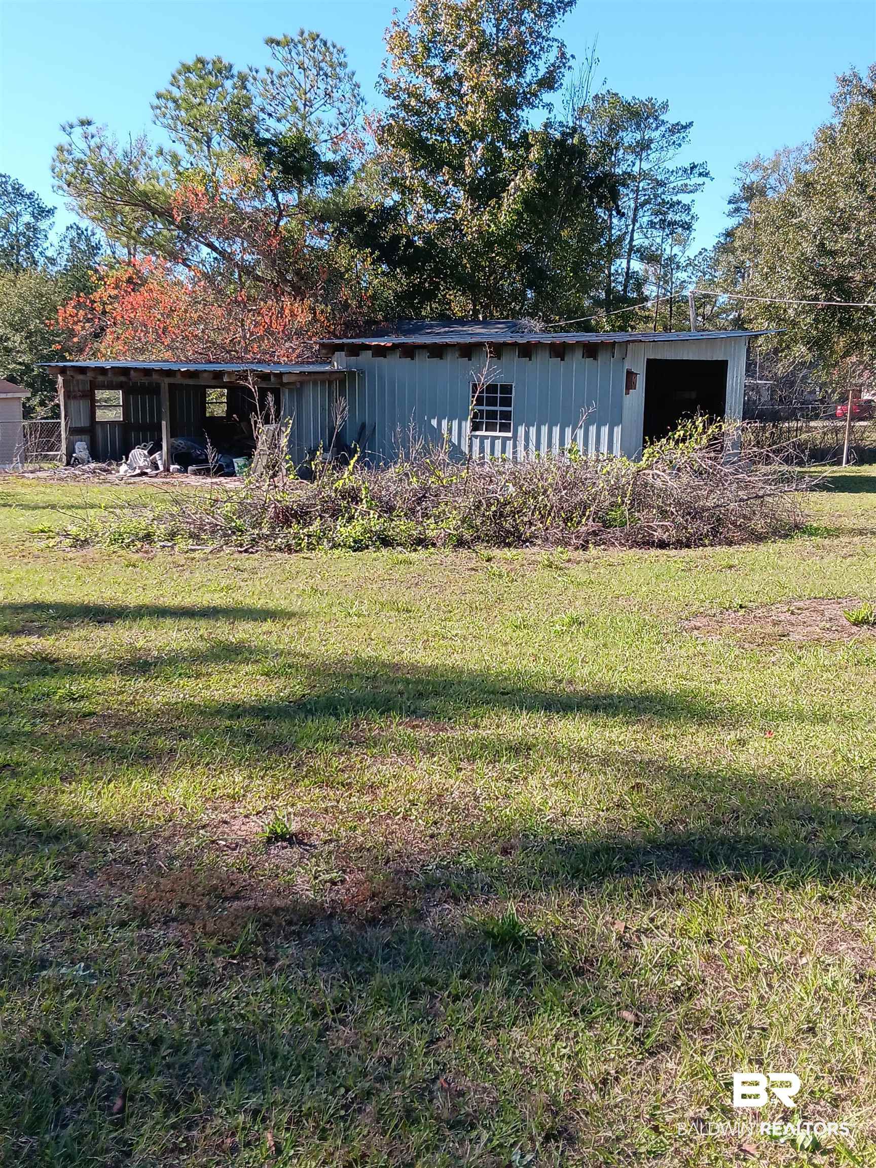 61 Katherine Street Flomaton, AL 36441 - Photo 13 of 13 View of front of home with an outdoor structure and a front yard