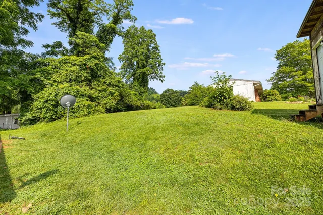 a view of a backyard with swimming pool