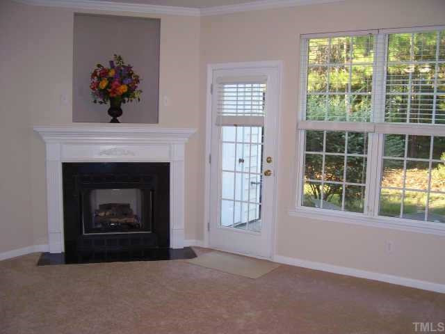 4724 Black Mountain Path Raleigh, NC 27612 - Photo 4 of 8 Sunny living room with marble-surround gaslog fireplace; t.v.niche;step out of family room onto private,wooded patio. Other