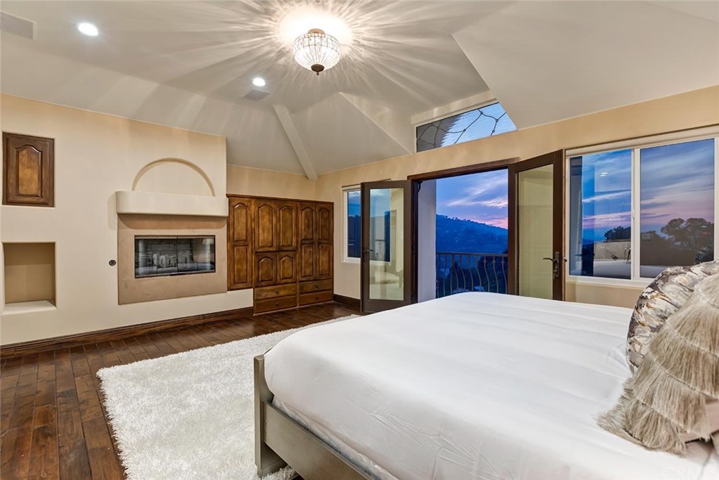 3263 Tareco Drive Los Angeles, CA 90068 - Photo 21 of 71 a spacious bedroom with a bed and a dresser next to a window