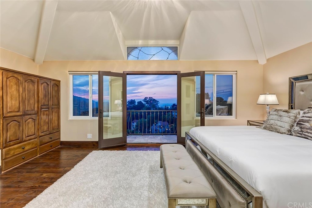 3263 Tareco Drive Los Angeles, CA 90068 - Photo 22 of 71 a bedroom with a large bed and a painting on the wall