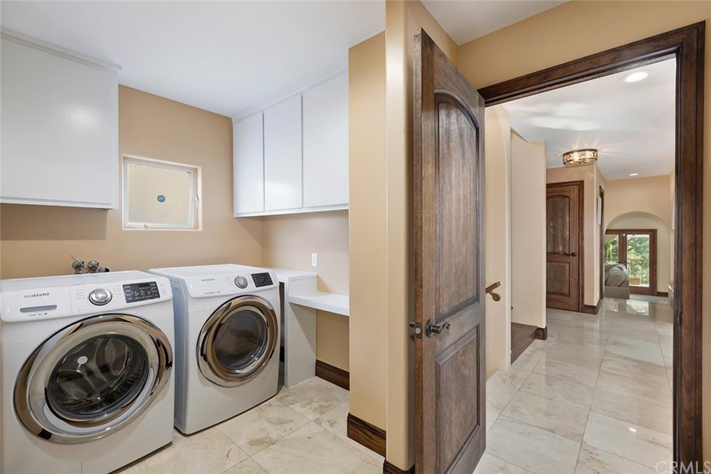 3263 Tareco Drive Los Angeles, CA 90068 - Photo 50 of 71 a view of a storage & utility room with dryer and washer