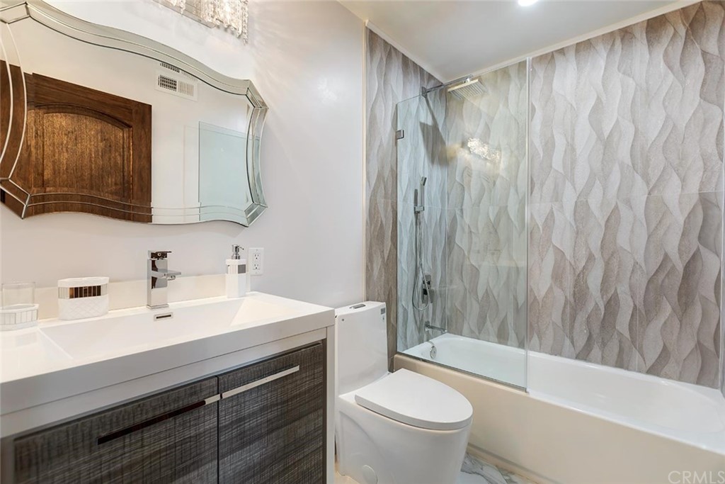 3263 Tareco Drive Los Angeles, CA 90068 - Photo 65 of 71 a bathroom with a sink a toilet a mirror and shower