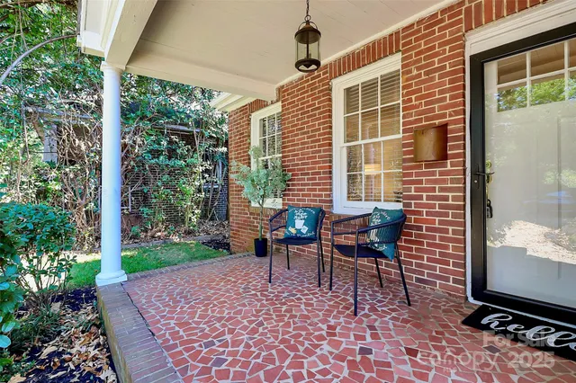a view of a patio with table and chairs and potted plants