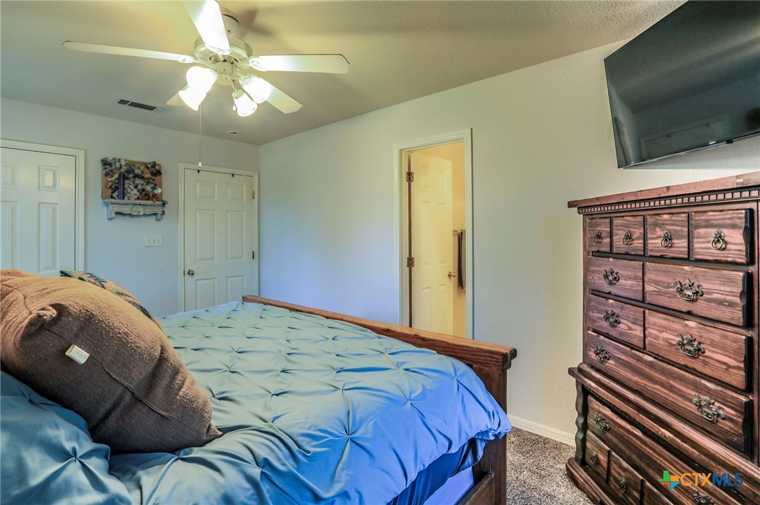 17 South Archer Drive Morgan's Point Resort, TX 76513 - Photo 11 of 30 a bedroom with a bed and a flat screen tv