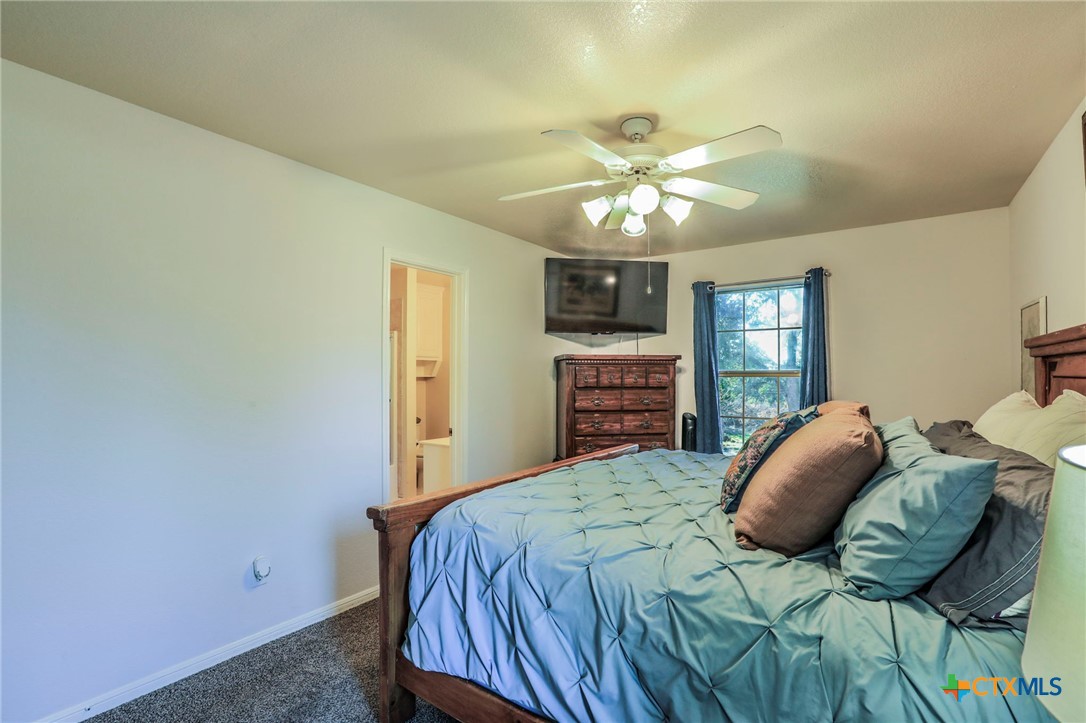 17 South Archer Drive Morgan's Point Resort, TX 76513 - Photo 12 of 30 a bedroom with a bed and ceiling fan